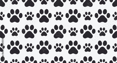 Seamless pattern of black paw prints of various sizes on a light gray background