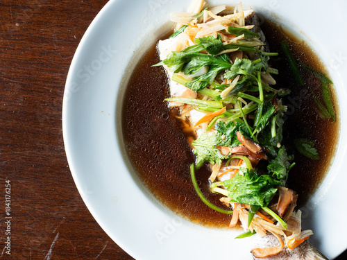 top view steamed fish in soy sauce