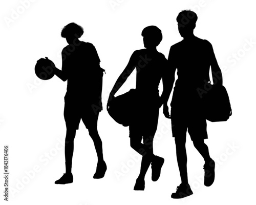 Four young men walking together outdoors on a sunny day.