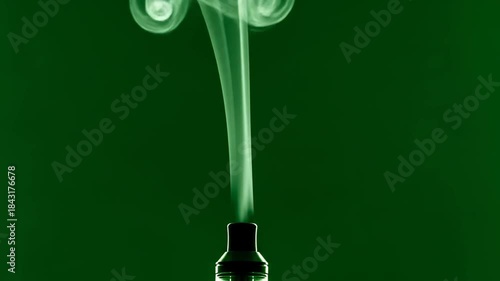 Elegant Green Vapor Swirls from Vape Device Against Green Background
