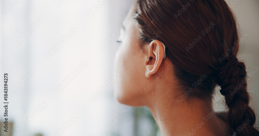 Fototapeta premium Thinking, woman and relax with hearing aid at house with ear device, sound and auditory assistance. Space, technology and female person with disability, deaf and audio implant with speech reflection