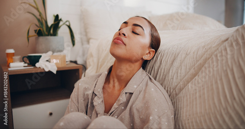 Fotografija Woman, sick and stress on floor in bedroom with eyes closed, recovery and illness with flu virus at apartment
