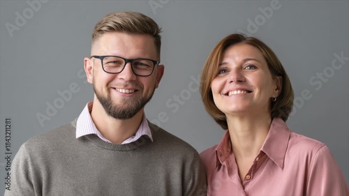 two happy caucasian office workers standing together and looking at the camera