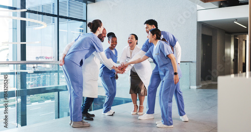 фотографія Excited, nurses and doctors with handstack in hospital for celebration, surgery success and victory