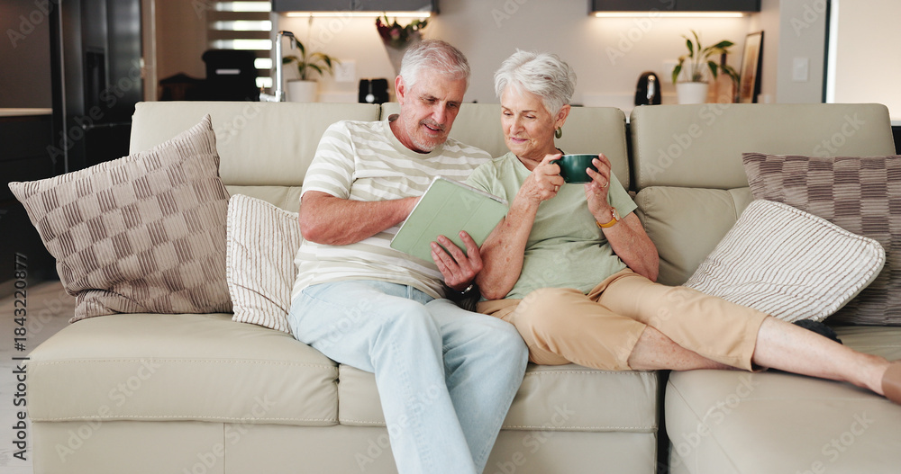 Obraz premium Coffee, relax and tablet with old couple on sofa in living room of home together for streaming. App, conversation and break with happy senior people drinking beverage in apartment for entertainment