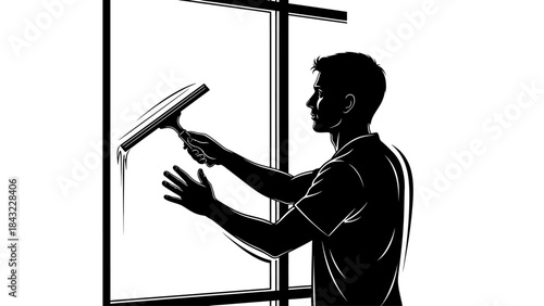 Man cleaning window with squeegee in a well-lit environment from a side view