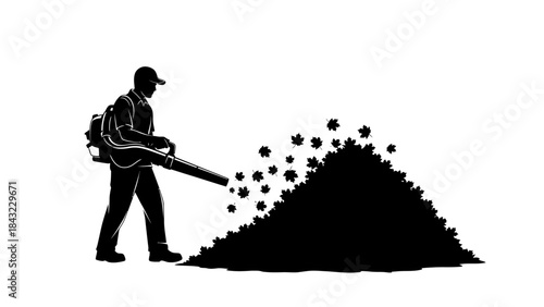Silhouette of a person blowing leaves into a pile with a leaf blower