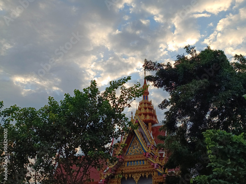Beautiful evening clouds and the temple roof with its shadows of trees.