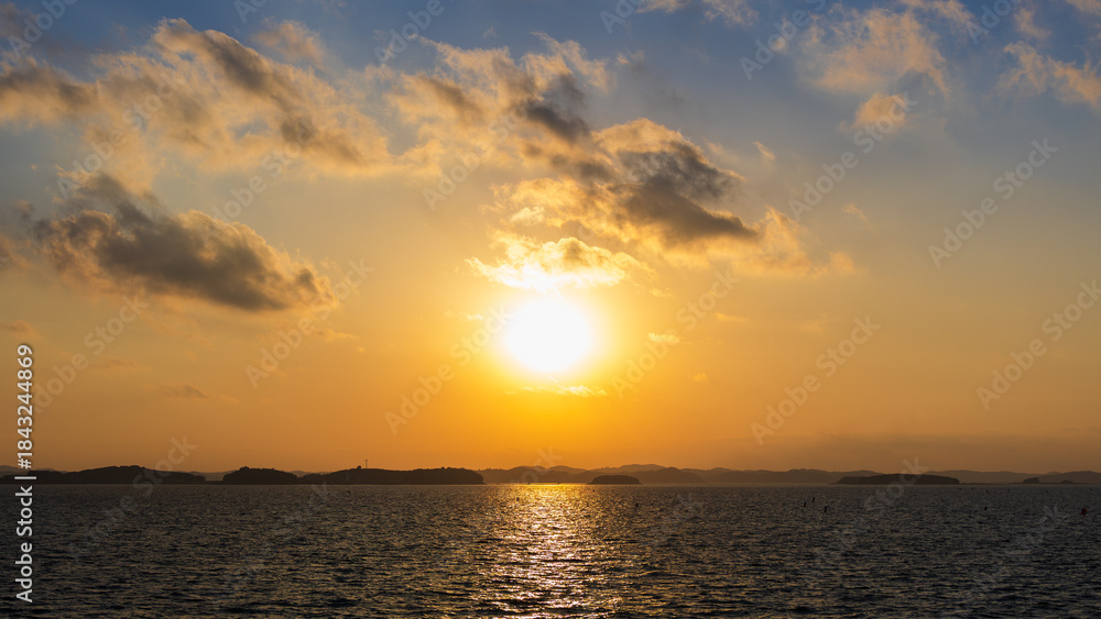 Fototapeta premium Sunset Sky and Layered Clouds Over the Sea