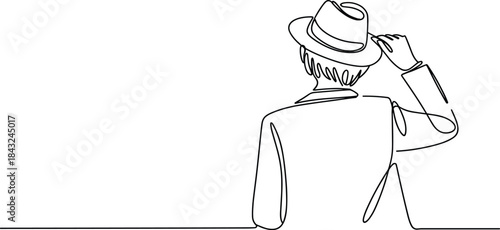 Man in Cowboy Hat Adjusting It While Walking