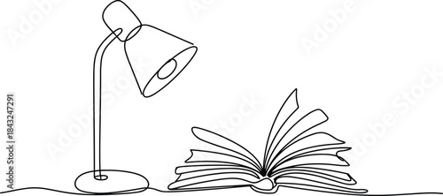 Open book with desk lamp reading