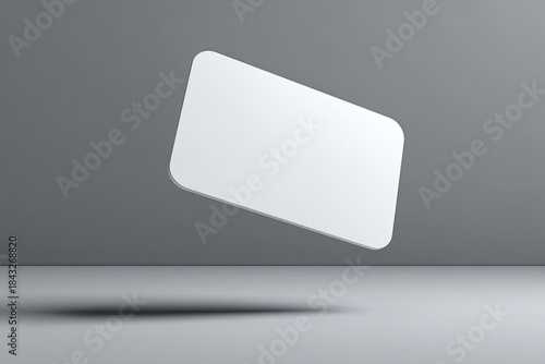A blank, hovering, rectangular object with rounded corners, against a simple grey backdrop