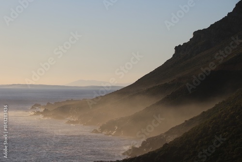 Golden Mist: Atmospheric Sunrise Over the Rugged South African Coastline