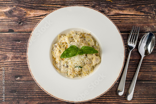 Tableau sur toile Creamy mushroom pasta topped with grated Parmesan and fresh basil