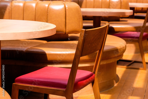 Wooden chairs and tables in a cafe, closeup of photo