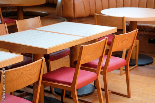 Wooden chairs and tables in a cafe, closeup of photo