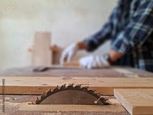 Close-up of Table Saw with Carpenter in Woodworking as Blurred Background.