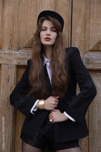  beautiful young slavic woman with long dark natural hair in elegant clothes