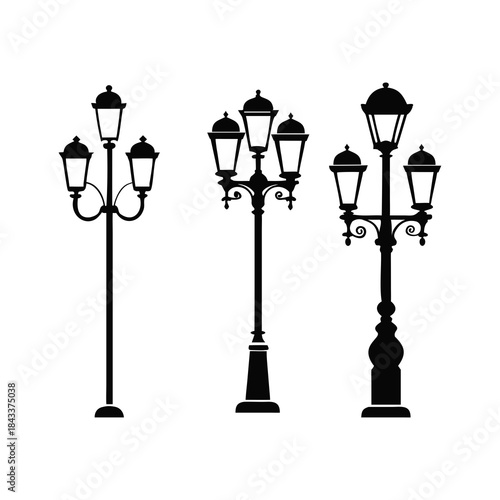 Collection of three black silhouette vintage street lamps on white background