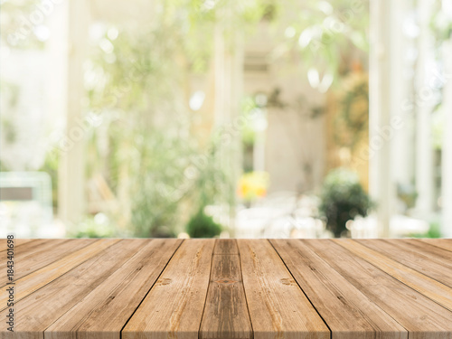 Warm wooden tabletop with blurred garden background