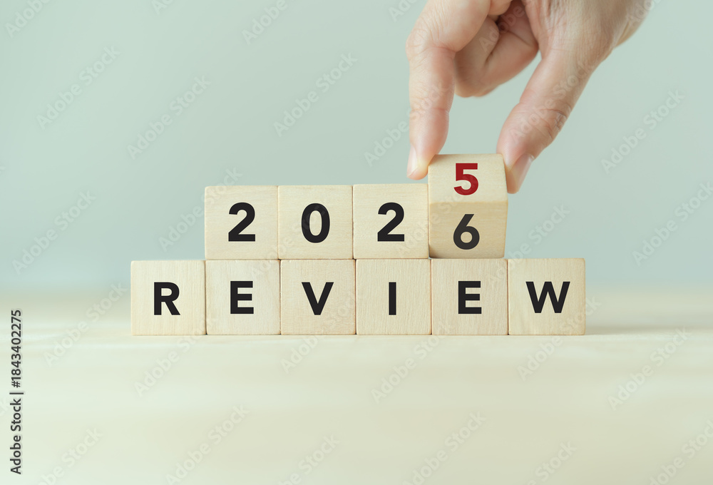 Fototapeta premium 2025 business review, flipping of 2025 to 2026 on wooden blocks. Business and customer review for business strategic planning for the next year 2026. End of the year business.