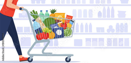 Woman pushing a shopping cart full of groceries in a supermarket.