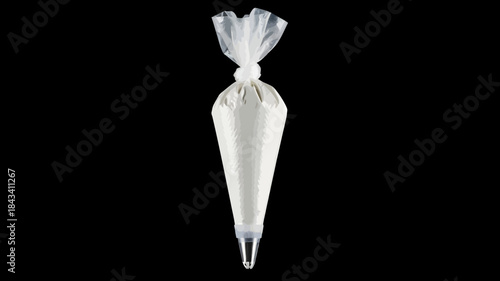 Flower in a vase on contrasting white and black backgrounds with decorative ribbon and leaves