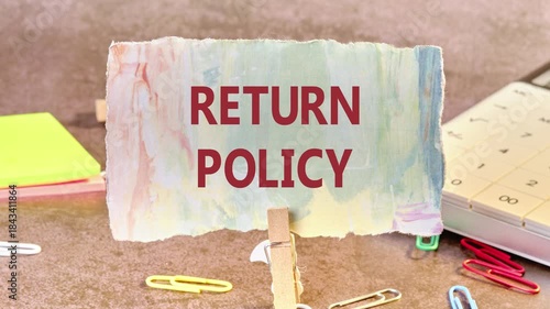 The conceptual phrase RETURN POLICY appears on a piece of paper fixed in a clothespin Conceptual business symbol. Copy space