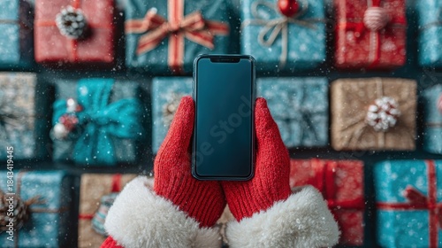 Santa hand holding mobile phone with empty screen in christmas day,holiday shopping online,light background,smartphone,banner sale gifts,Blank white screen,Mockup.