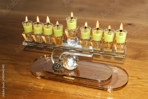Modern Hanukkah with lit candles and a dreidel are the main symbols of the Jewish holiday of Hanukkah