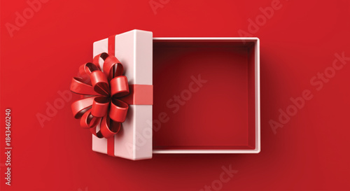 An overhead view of an empty white gift box, partially open, featuring a large, elaborate red ribbon and bow attached to the lid, set against a vibrant, solid red background.