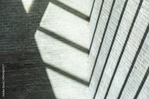 Geometric shadows on brick wall cast by roof construction