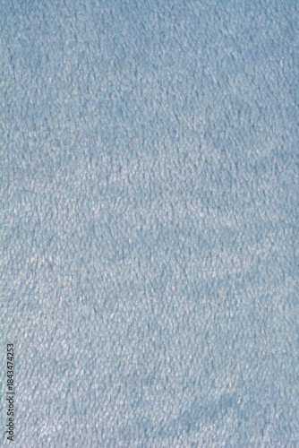 A soft light blue fleece fabric texture is shown in a vertical close up