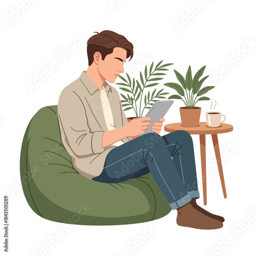 Relaxed man using tablet on beanbag chair with coffee and plants nearby
