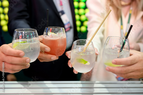 Group Toasting with Lime Cocktails at Stylish Event