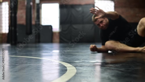 Selective focus blurred out background video of mma gym, martial arts boxing, kickboxing, training, wrestling jiujitsu, people training, jiujitsu warmup