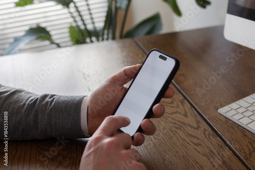 hands holding phone with empty blank white screen, man using smartphone