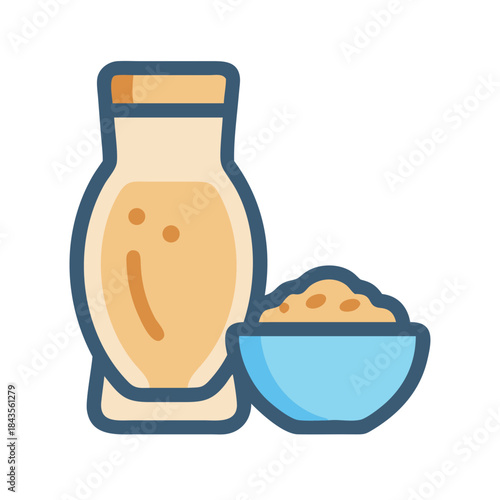 Oat milk in jar next to cereal in bowl