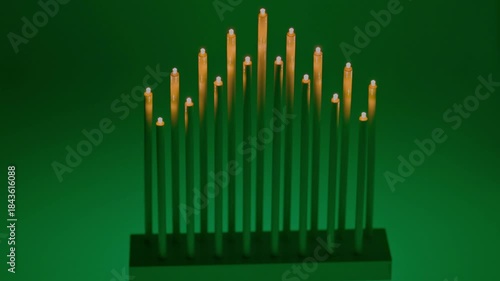Glowing decorative candles standing in row with background softly blinking in warm fire inspired colors. Sweden.