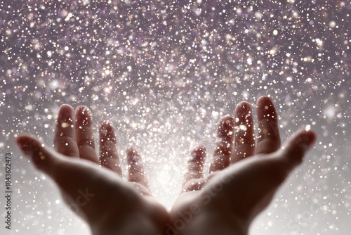 Hands and Glitter: A close-up shot captures open hands reaching upwards, as glittering particles cascade from above, creating a magical and ethereal atmosphere.
