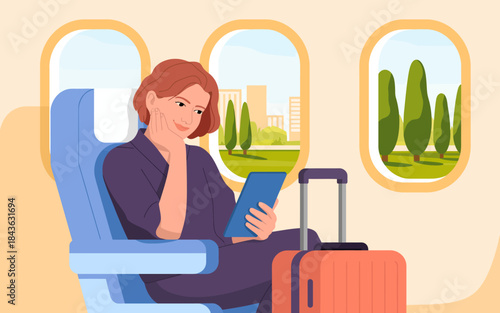 A relaxed woman enjoys her time on a flight while reading on her tablet, with a scenic view of city landscapes through the airplane window in the background.