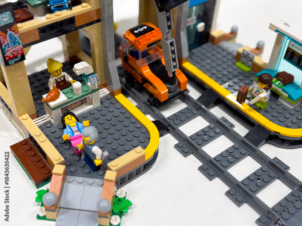 Fototapeta premium Colorful lego city scene with train station and cafe