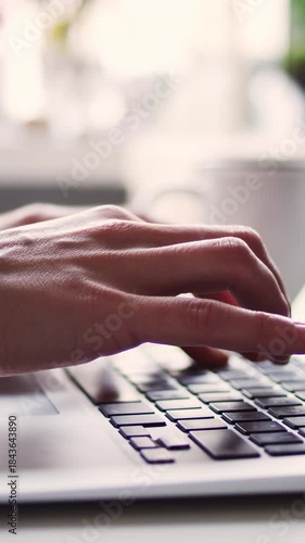 Close-up hands typing an e-mail on a keyboard or working remote