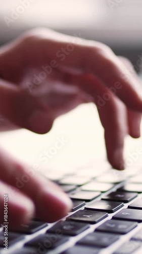 Close-up hands typing an e-mail on a computer keyboard or working remote