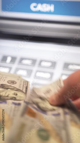 A man withdraws cash from an ATM. Banking services, cash withdrawals