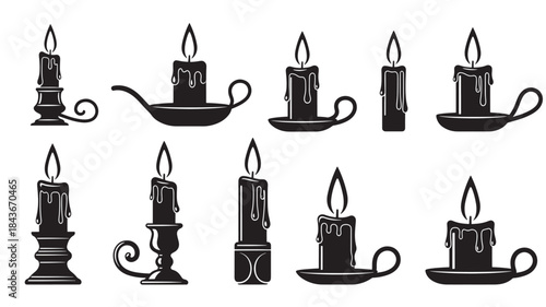 Black Candles Burning in Various Holders on White Background