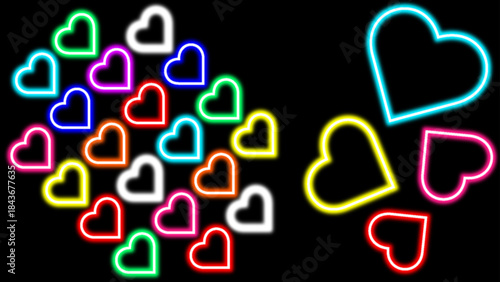 A vibrant collection of colorful neon heart shapes glowing brightly against a dark background creating a festive and romantic atmosphere for celebrations and expressions of love