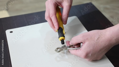 Wallpaper Mural Woman sanding vintage sugar chopping tongs with a small felt disc. Handheld sander removing patina from old metal kitchenware restoration. Torontodigital.ca