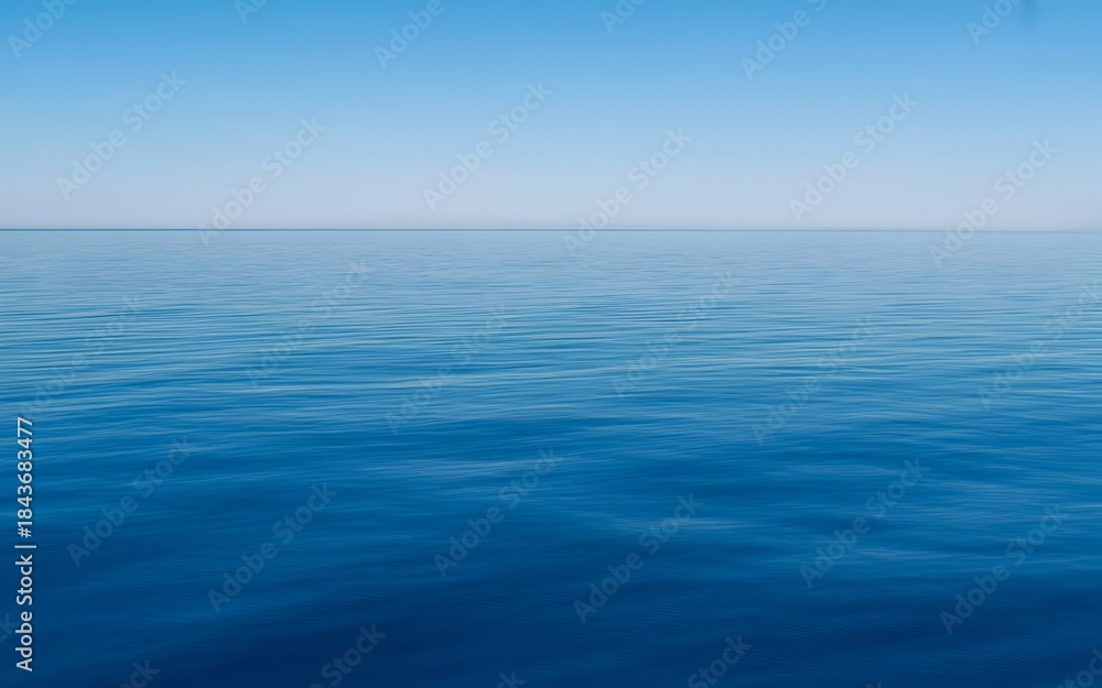 Obraz premium Calm Blue Ocean with Clear Sky Minimalist Seascape Background,Peaceful Open Sea and Blue Sky Horizon Nature Landscape,Blue Sea and Sky Background,Serene Blue Ocean Horizon with Natural Sky