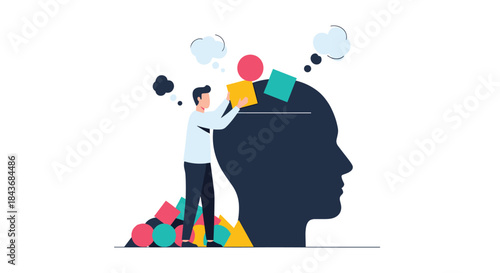 Man organizing his thoughts and ideas by placing colorful geometric shapes into a large human head silhouette concept.